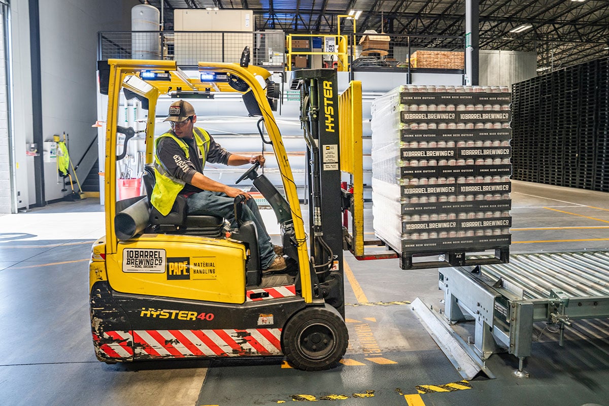 A warehouse employee reversing a forklift truck, Health and Safety Management Software | Be-Safe