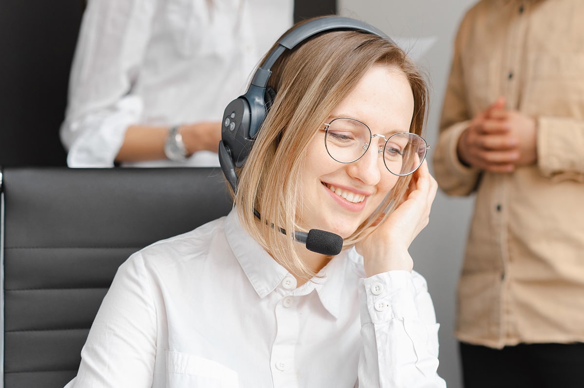 An office worker wearing a headset. Health and Safety Compliance Software