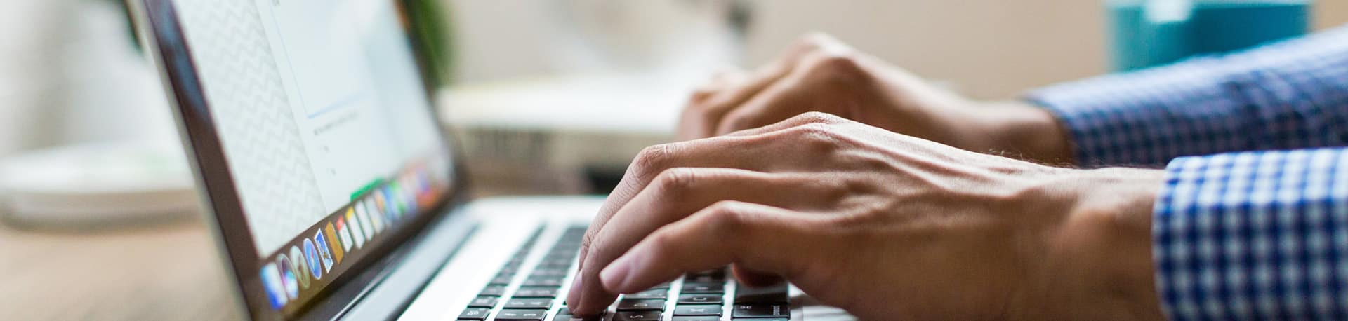 A close up of a man's hands as he is typing on a laptop, Health and Safety Software System